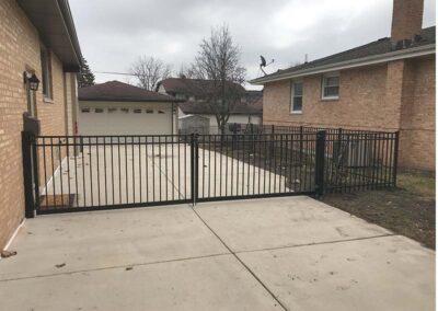 a black aluminum fence gate