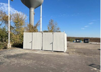 a white fence around a water tower