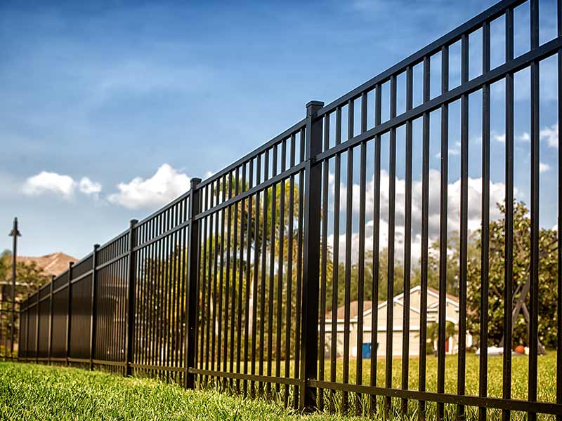 A black aluminum fence built by SJ Fence company