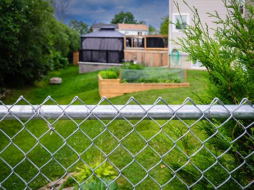 A chain link fence around a home